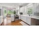 Bright kitchen featuring white cabinetry, stainless steel appliances, and hardwood floors at 83 Shipp Cir, Hiram, GA 30141