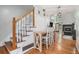 Elegant living area featuring hardwood floors, stairs, dining table, and a cozy fireplace at 83 Shipp Cir, Hiram, GA 30141
