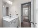 Bathroom view with neutral colors, a large mirror, modern fixtures, and access to another room at 1666 Baxley Pine Trce, Suwanee, GA 30024