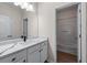 Bathroom featuring white cabinets, a large mirror, and a combination tub and shower at 1666 Baxley Pine Trce, Suwanee, GA 30024