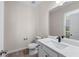 Half bath with toilet, vanity, modern fixtures, and a large mirror that brings depth to the space at 1666 Baxley Pine Trce, Suwanee, GA 30024