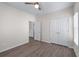 Bedroom featuring wood-look flooring, a ceiling fan and a double door closet at 1666 Baxley Pine Trce, Suwanee, GA 30024