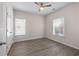 Bedroom with two windows, a ceiling fan, and a closet with double doors at 1666 Baxley Pine Trce, Suwanee, GA 30024