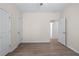 Bedroom featuring neutral walls, wood-look flooring, and multiple closets at 1666 Baxley Pine Trce, Suwanee, GA 30024