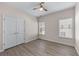Bedroom features neutral walls, wood-look flooring, windows and a closet with double doors at 1666 Baxley Pine Trce, Suwanee, GA 30024