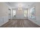 Open dining room with hardwood floors, chandelier, and large windows, perfect for entertaining at 1666 Baxley Pine Trce, Suwanee, GA 30024