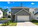 Rear exterior elevation of a two story home with a two car garage at 1666 Baxley Pine Trce, Suwanee, GA 30024