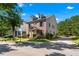 A well-maintained home, boasting lush landscaping, a brick facade, and a private driveway at 1666 Baxley Pine Trce, Suwanee, GA 30024