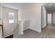 Hallway with hardwood-style flooring and a staircase leading to the lower level at 1666 Baxley Pine Trce, Suwanee, GA 30024