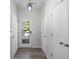 Hallway featuring entry door, access to rooms, neutral paint, and consistent flooring throughout at 1666 Baxley Pine Trce, Suwanee, GA 30024