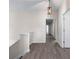 Hallway with hardwood-style flooring and a modern pendant light fixture at 1666 Baxley Pine Trce, Suwanee, GA 30024