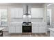 Modern kitchen featuring white cabinets, stainless steel appliances, and quartz countertops at 1666 Baxley Pine Trce, Suwanee, GA 30024