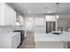 Bright, updated kitchen with white cabinetry, quartz countertops, and stainless steel appliances at 1666 Baxley Pine Trce, Suwanee, GA 30024