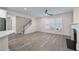 Living room view with hardwood floors, a staircase, large windows, and a fireplace at 1666 Baxley Pine Trce, Suwanee, GA 30024