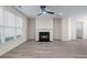 Spacious living room with a fireplace, large windows, and neutral paint colors, creating a welcoming atmosphere at 1666 Baxley Pine Trce, Suwanee, GA 30024