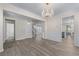 Inviting living area with hardwood flooring, an elegant chandelier, and an open layout for gatherings at 1666 Baxley Pine Trce, Suwanee, GA 30024