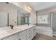 Bright main bathroom with double vanity, a soaking tub, and glass shower at 1666 Baxley Pine Trce, Suwanee, GA 30024