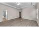 Spacious main bedroom with ensuite bathroom, large windows, and wood-look floors at 1666 Baxley Pine Trce, Suwanee, GA 30024