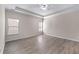 Spacious main bedroom with tray ceilings, large windows, and wood-look floors at 1666 Baxley Pine Trce, Suwanee, GA 30024