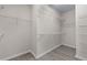 Walk-in closet with white wire shelving and wood-look floors at 1666 Baxley Pine Trce, Suwanee, GA 30024