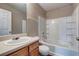 Traditional bathroom features a tub with tile surround, vanity and toilet at 2289 Strathmoor Manor Dr, Lithonia, GA 30058