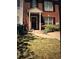 Charming red brick home with a welcoming entryway, decorative door wreath, and well-maintained lawn at 2289 Strathmoor Manor Dr, Lithonia, GA 30058
