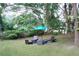 The backyard has a patio area with lounge chairs and an umbrella at 3046 Dobbs Way, East Point, GA 30344