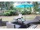 Backyard with patio featuring outdoor seating, lounge chairs, and a blue umbrella at 3046 Dobbs Way, East Point, GA 30344