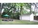Large backyard with a shed, mature trees and an outdoor seating area at 3046 Dobbs Way, East Point, GA 30344