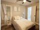 Bright bedroom featuring neutral decor, a bed with plush pillows and white decor, and luxury vinyl plank floor at 3046 Dobbs Way, East Point, GA 30344