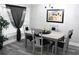 Bright dining area with gray table, chairs with ribbons, and sheer black curtain at 3046 Dobbs Way, East Point, GA 30344