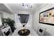 Gray dining area with a decorative centerpiece and sheer black curtain at 3046 Dobbs Way, East Point, GA 30344
