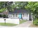 Charming single-story home with light gray exterior, cute shutters, and a vibrant blue front door at 3046 Dobbs Way, East Point, GA 30344