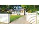 Street view of a cozy home featuring a well-manicured lawn and white wooden fence at 3046 Dobbs Way, East Point, GA 30344