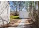 The garage has white siding and is at the end of a driveway with gravel at 3046 Dobbs Way, East Point, GA 30344