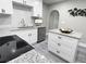 Open concept kitchen with white cabinets, stainless steel appliances, and an island at 3046 Dobbs Way, East Point, GA 30344