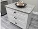 Close-up of a kitchen island with white cabinets and a granite countertop at 3046 Dobbs Way, East Point, GA 30344