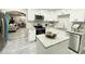 Modern kitchen with white cabinets, granite countertops, and gray flooring at 3046 Dobbs Way, East Point, GA 30344