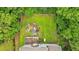 Aerial view of the property showcasing the backyard pond and mature landscaping at 345 Riverstone Dr, Hiram, GA 30141