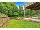 Lush backyard with landscaped garden area, wooden bridge, and wooded backdrop at 345 Riverstone Dr, Hiram, GA 30141