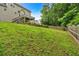 Expansive backyard with lush green lawn and the home's back deck at 345 Riverstone Dr, Hiram, GA 30141