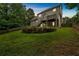Well-maintained backyard featuring a stone retaining wall and lush lawn at 345 Riverstone Dr, Hiram, GA 30141