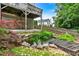Landscaped backyard pond with wooden bridge and lush foliage beneath deck at 345 Riverstone Dr, Hiram, GA 30141