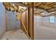 Unfinished basement with exposed wood framing, insulation, and a small window at 345 Riverstone Dr, Hiram, GA 30141