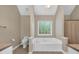 Bright bathroom featuring a large tub with tiled floors and neutral wall paint at 345 Riverstone Dr, Hiram, GA 30141