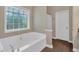 Bathroom features a tub with tile flooring and large window with natural lighting at 345 Riverstone Dr, Hiram, GA 30141