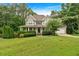 Charming two-story home with a welcoming front porch and manicured landscaping at 345 Riverstone Dr, Hiram, GA 30141