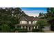 Charming two-story home with a welcoming front porch and manicured landscaping at 345 Riverstone Dr, Hiram, GA 30141