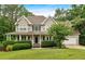 Charming two-story home with a welcoming front porch and manicured landscaping at 345 Riverstone Dr, Hiram, GA 30141