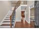Grand foyer with hardwood floors, elegant staircase, and views into the kitchen at 345 Riverstone Dr, Hiram, GA 30141